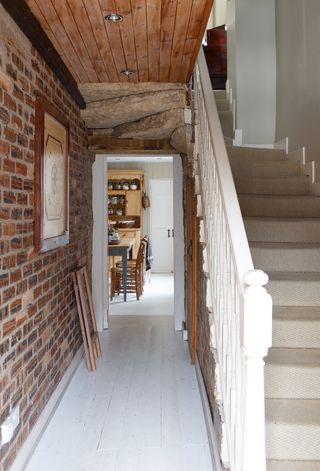 hallway with stairs leading upstairs and door through to kitchen