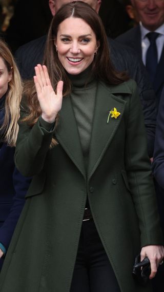 Catherine, Duchess of Cambridge waves to well-wishers during a visit to Abergavenny Market