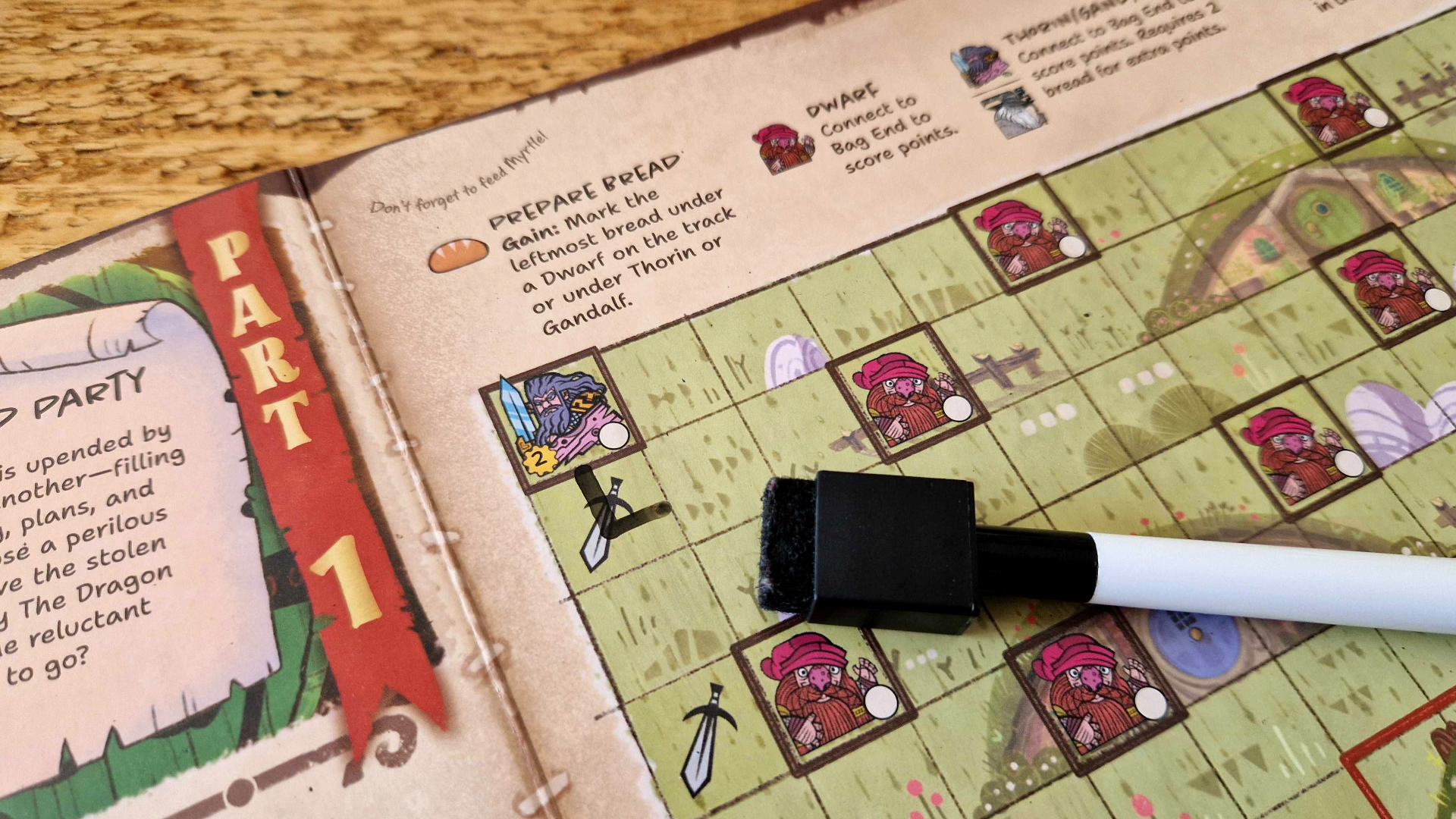 The Hobbit: There &amp;amp; Back Again components laid out on a wooden surface