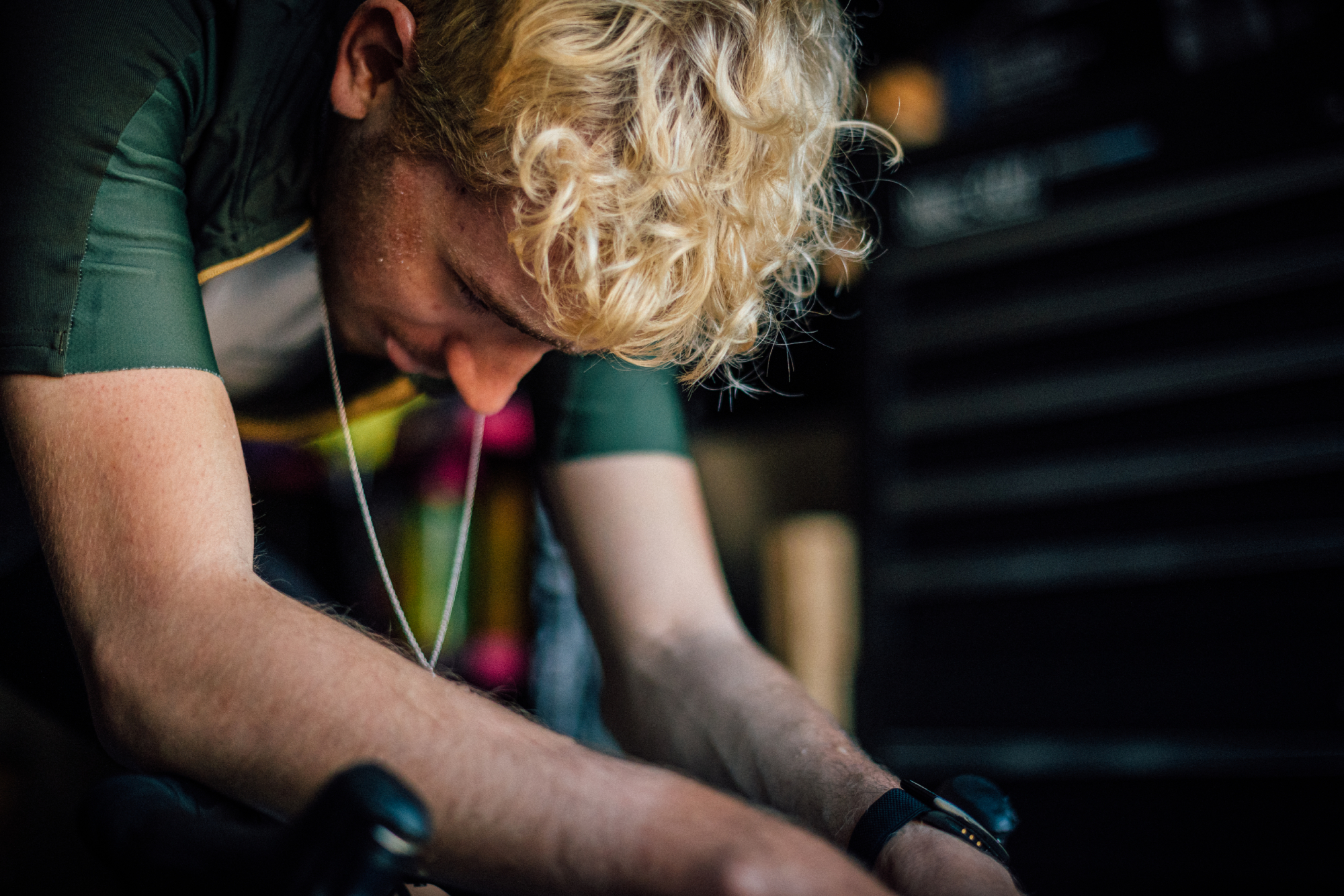 Male cyclist riding inside a dark garage