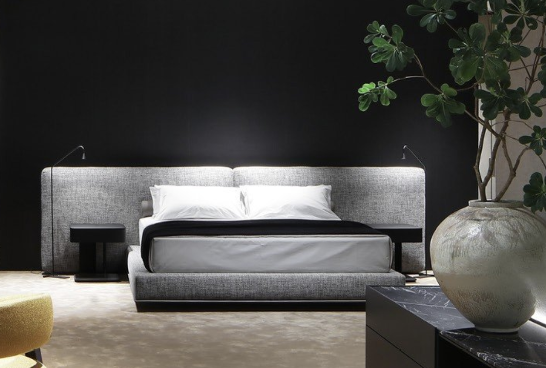 large gray bed in black bedroom