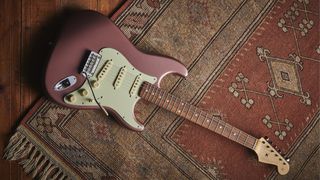 Fender Stratocaster laying on a rug