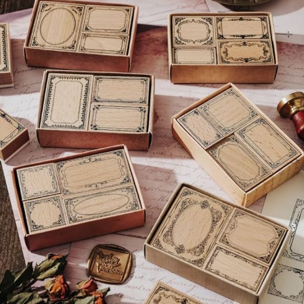 Sets of rubber stamps with decorative borders on a background featuring handwritten letters and wax seals