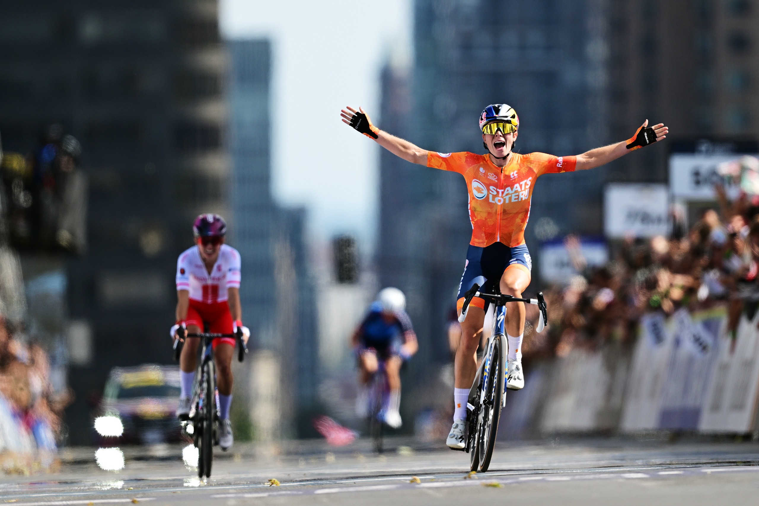 Demi Vollering celebrates as she crosses the finish line ahead of Kasia Niewiadoma to win the 2026 UCI World Championships women's elite road race in Montreal