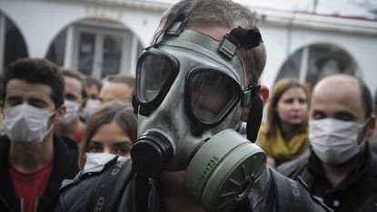 An Albania wearing a gas mask in protest of a plan to dispose of Syria's chemical weapons in Albania 