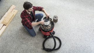 Man uses a Craftsman shop vacuum