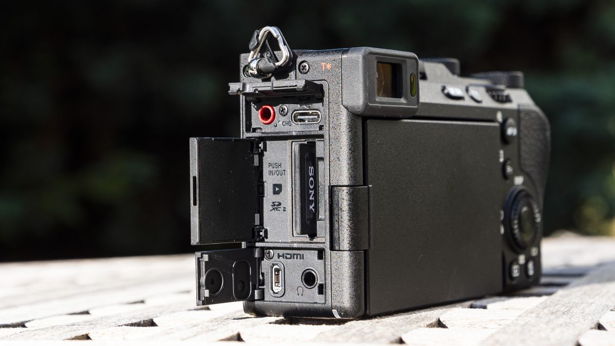 Side view of the ports of the Sony A7C R camera outside on a wooden table