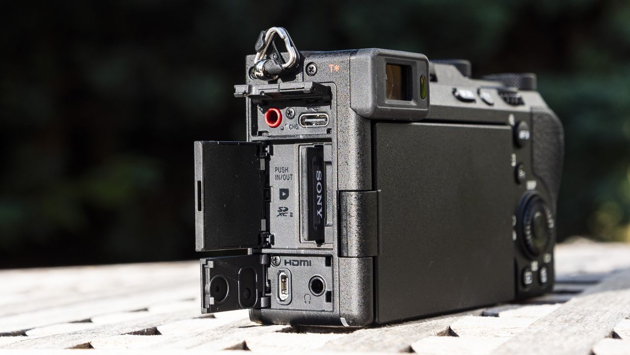 Side view of the ports of the Sony A7C R camera outside on a wooden table