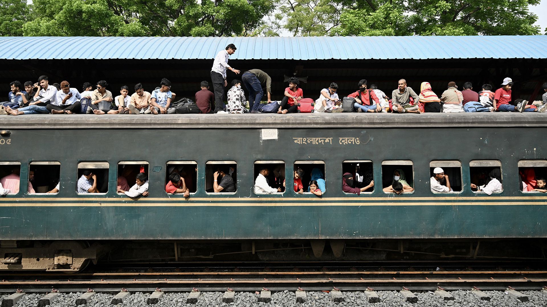 
                                People clamber onto the roof of a crowded train ahead of the Muslim festival of Eid al-Fitr in Tongi, Bangladesh
                            