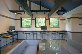 Interior view of the Karuizawa office with wood beams, sofas and bar desks