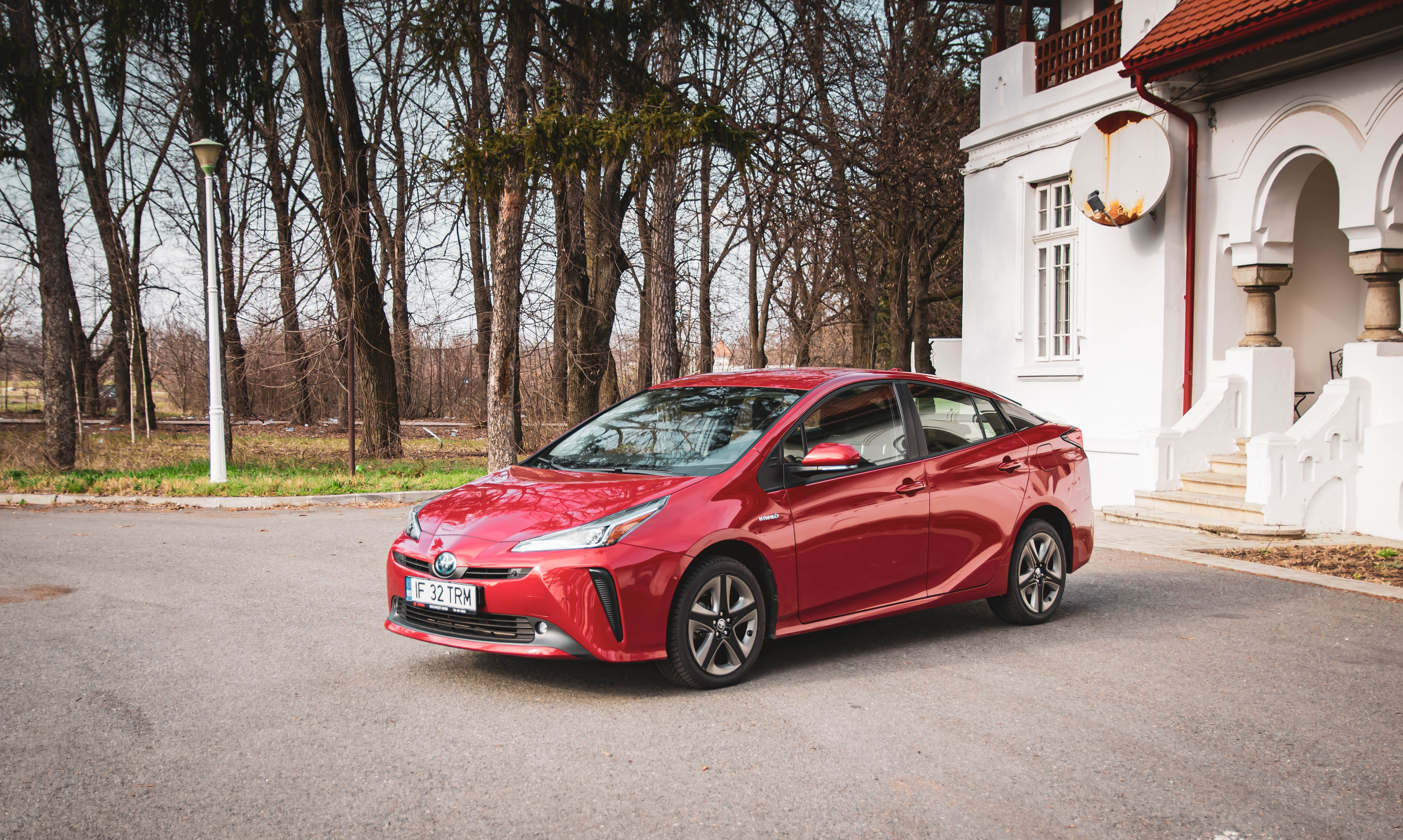 red toyota prius on driveway