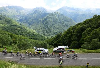 PLATEAU DE BEILLE FRANCE JULY 14 Remco Evenepoel of Belgium and Team Soudal QuickStep White Best Young Rider Jersey Tadej Pogacar of Slovenia and UAE Team Emirates Yellow Leader Jersey Jonas Vingegaard Hansen of Denmark and Team Visma Lease a Bike Polka Dot Mountain Jersey and a general view of the peloton climbing the Col Dagns 1570m during the 111th Tour de France 2024 Stage 15 a 1977km stage from Loudenvielle to Plateau de Beille 1782m UCIWT on July 14 2024 in Plateau de Beille France Photo by Tim de WaeleGetty Images