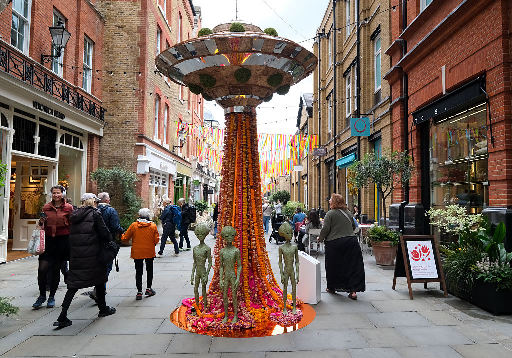 A UFO themed floral display, complete with grey aliens, on a street in Chelsea