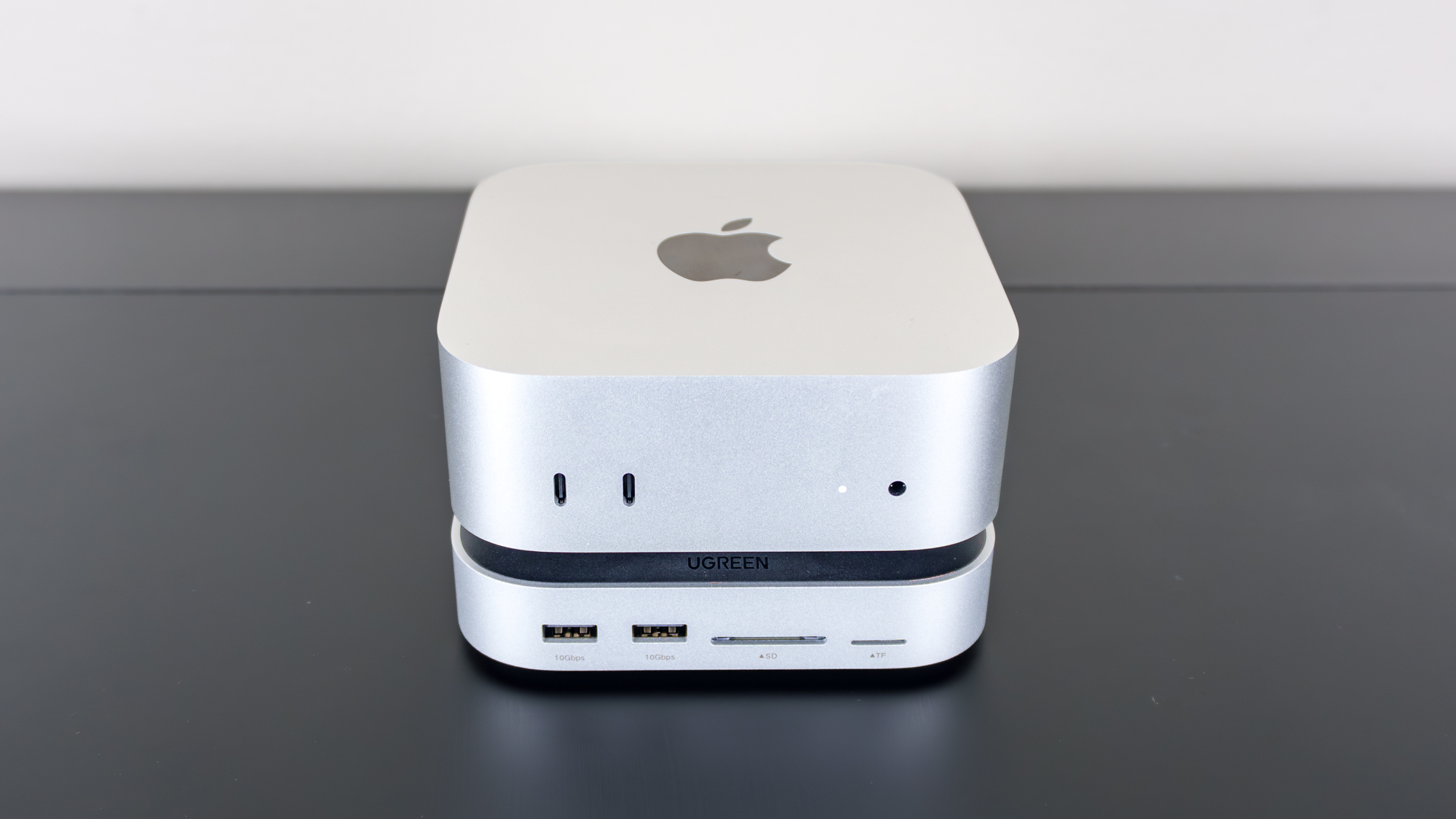 The Ugreen Mac Mini M4 Dock & Stand installed underneath a Mac mini M4 mini PC on a desk