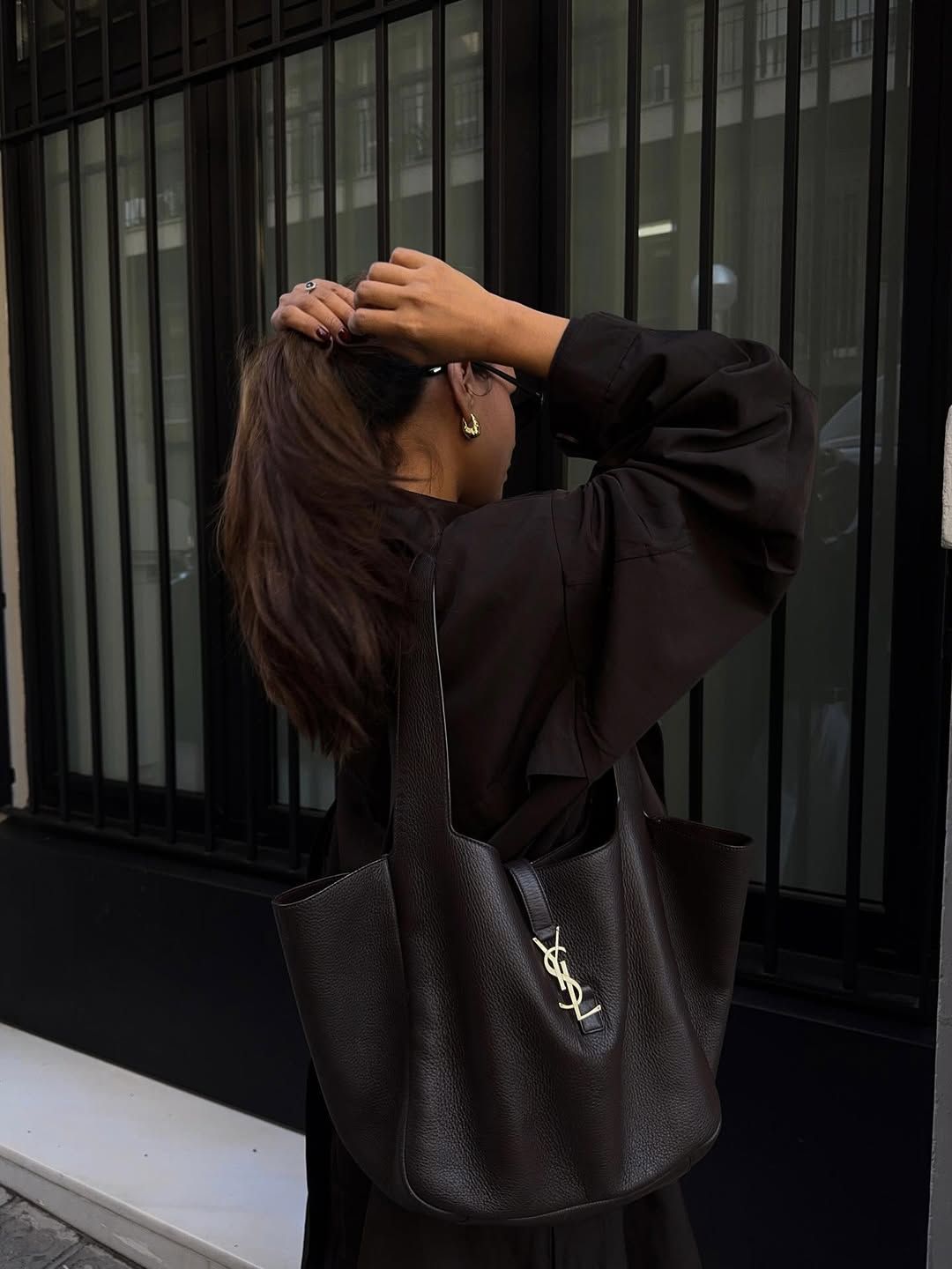 Brunette influencer holding the YSL Bea Tote.