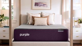 Image shows the Purple RestorePremiere Hybrid mattress on a four poster bedframe