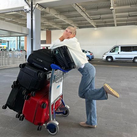 Caro Daur at the airport with suitcases