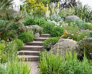 large boulders in flowerbeds and stone steps