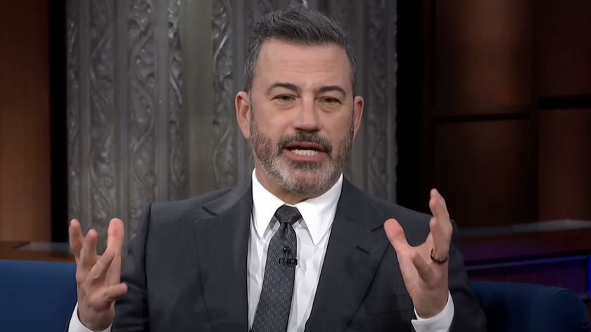 Jimmy Kimmel holding hands up during interview on The Late Show with Stephen Colbert