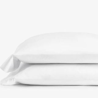 Two white pillowcases stacked on top one another