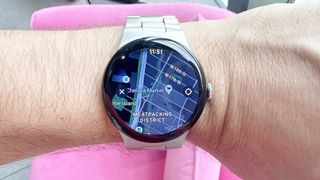 Google Pixel Watch 3 on a user's wrist against a pink background