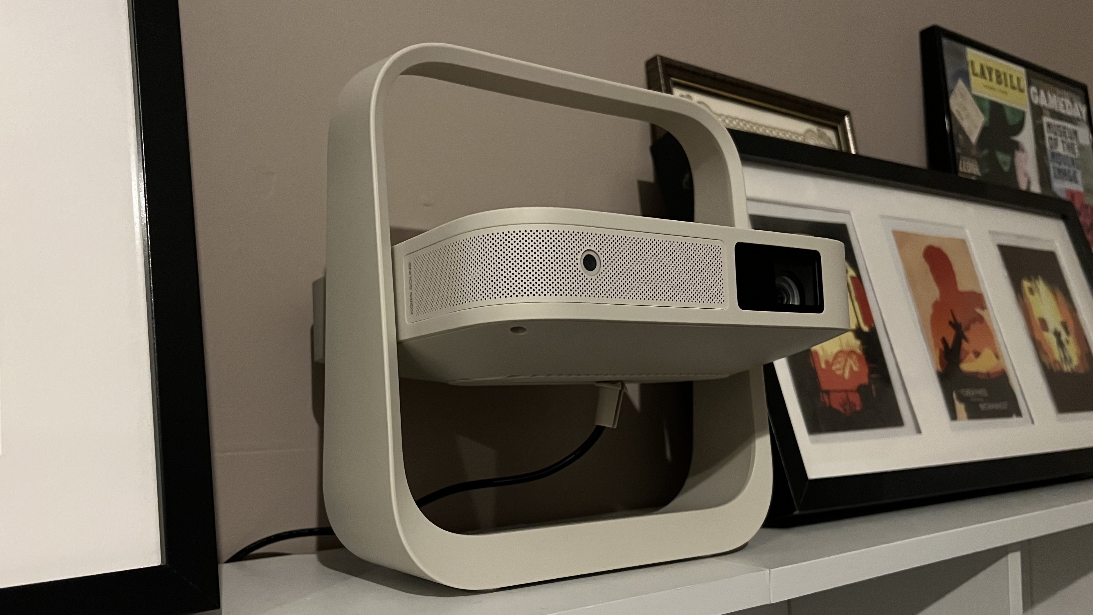 XGIMI Elfin Flip projector on a shelf alongside pictures