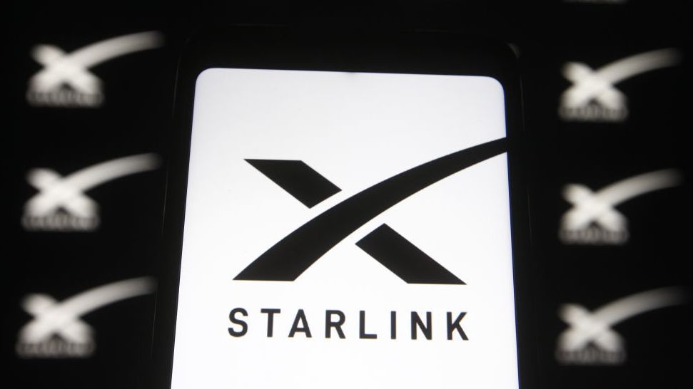 Close up of the Starlink logo, a stylised black &amp;#039;X&amp;#039; with the word starlink beneath on a white background, with other such logos in the background but blurry