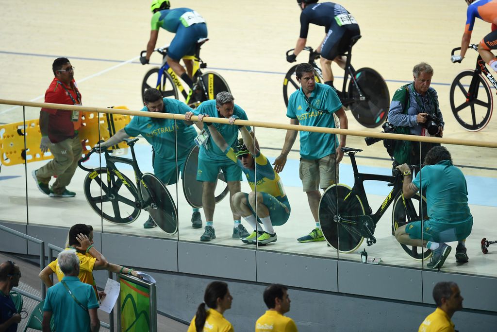 The Australian officials help out Glenn O'Shea after the crash