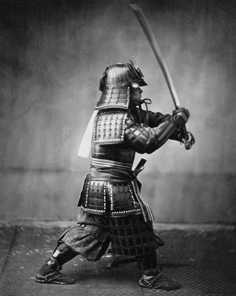 A Samurai in full armor with sword. 