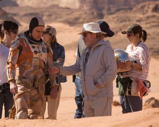 Ridley Scott Directs Matt Damon: Discussing a pivotal plot point, revolving around a piece of equipment penetrating an EVA suit.