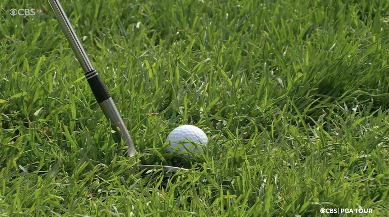 A close up of Hideki Matsuyama&#039;s wedge behind a ball