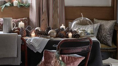 Dining table with wreath and pine cone centrepiece