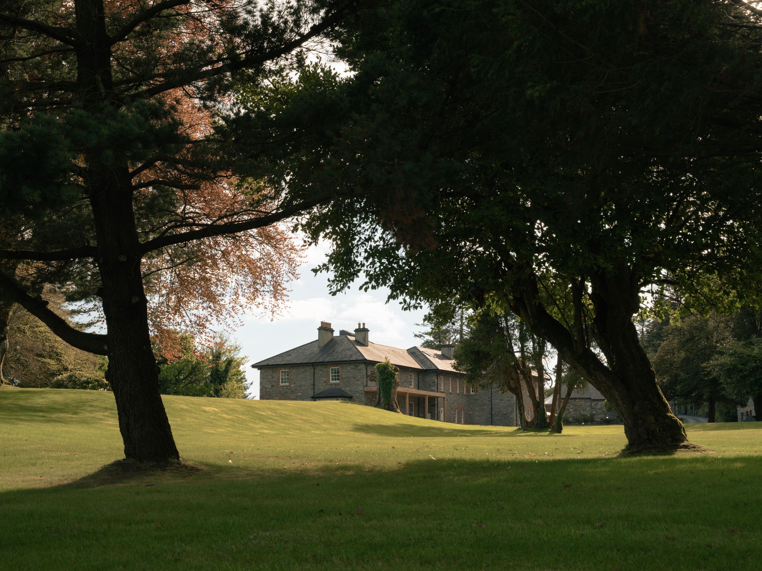 The house is set within mature landscaped gardens