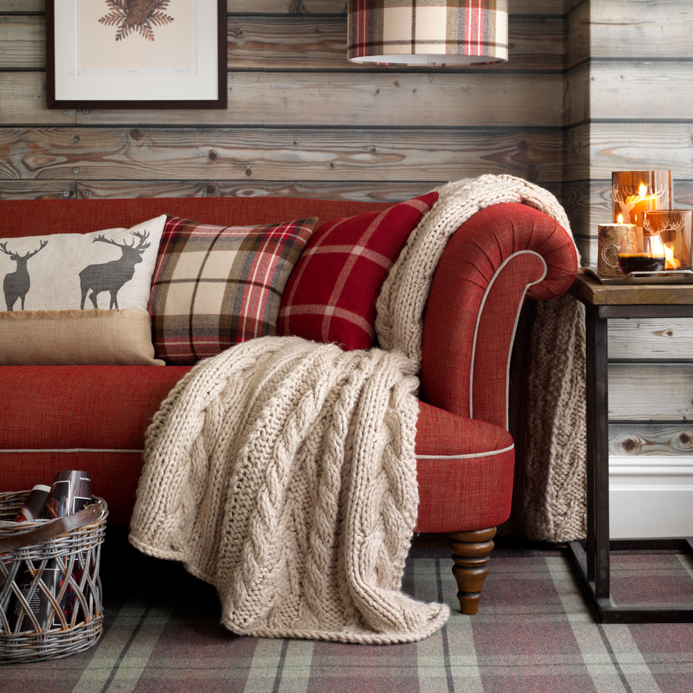 living area with sofaset with cushions and photoframe on wall