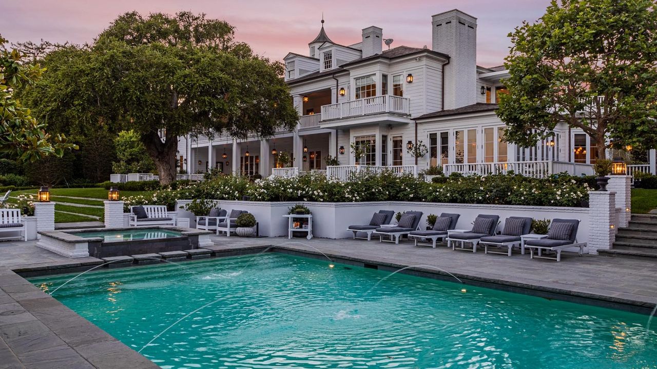 the back of Adam Levine&#039;s Montecito home, with the pool in the foreground and house in the background