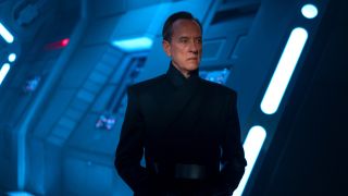 Richard E. Grant stands in the shadows on an Imperial ship in Star Wars: The Rise of Skywalker.