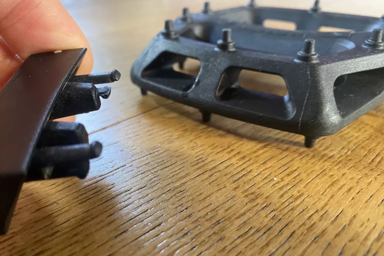 Image shows the DMR V6 flat pedals mounted on a bike
