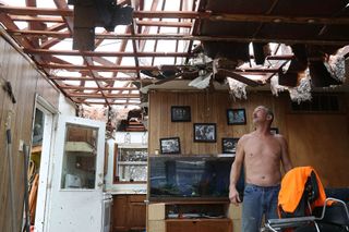 Aaron Tobias, who said he lost everything, stands in what is left of his home after Hurricane Harvey blew in and destroyed most of the house on Aug. 26, 2017, in Rockport, Texas.