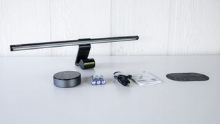 The Quntis RGB Pro+ monitor light bar and all of its accessories on a table