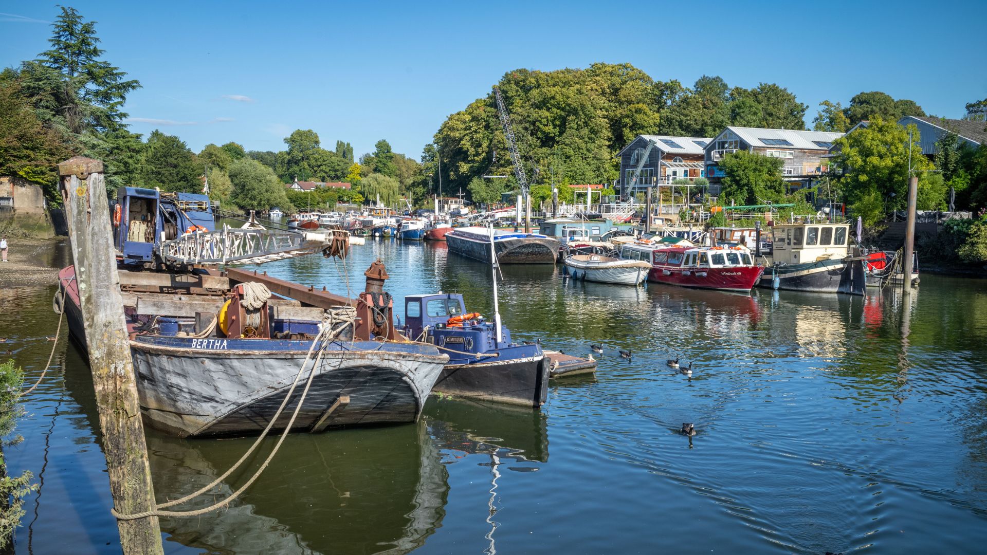 an image of pleasure boats and barges moored on the River Thames at Twickenham next to Eel Pie Island to the west of London. (Photo by: Andy Soloman/UCG/Universal Images Group via Getty Images)