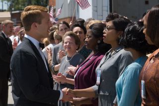 Katherine G. Johnson, played by Taraji P. Henson, is joined by her co-workers Dorothy Vaughan (Octavia Spencer) and Mary Jackson (Janelle Monáe) as she greets astronaut John Glenn (Glen Powell), the man destined to become the first American to orbit Earth.