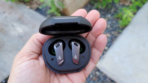 The Edifier NeoBuds Pro earbuds held in the palm of a hand