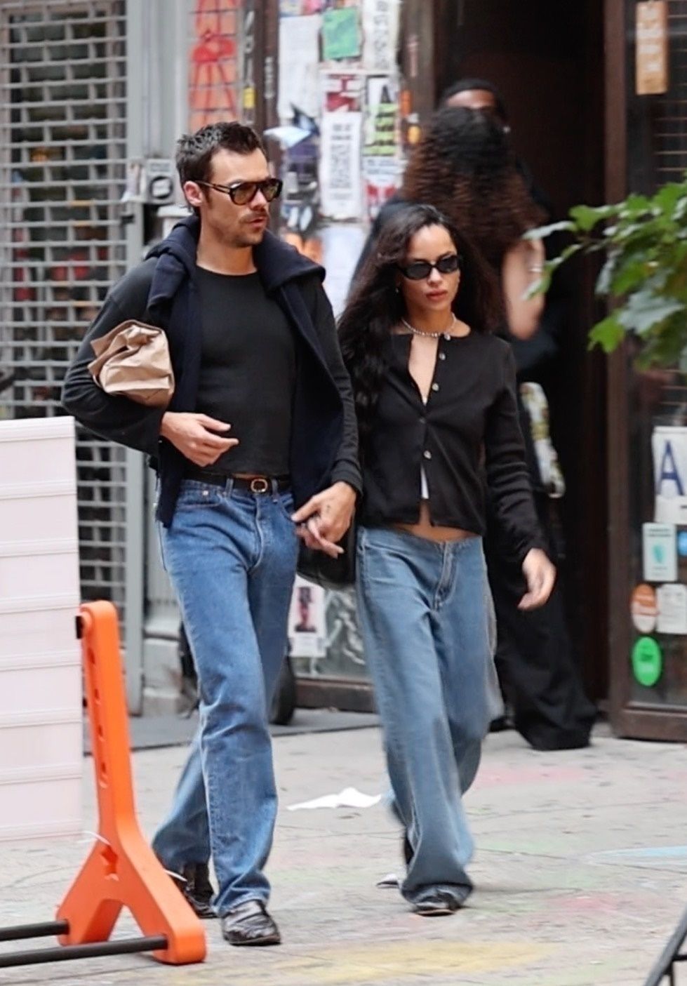Zoë Kravitz in low-rise jeans and black cardigan