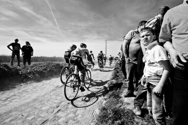 A boy watches the race.