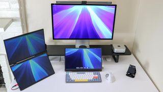 A multi-monitor setup built around the Mac mini M4 and the Apple Studio Display on an Oakywood Desk Shelf