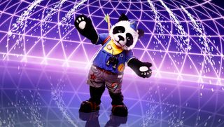 The Masked Singer 3 contestant Panda - a cute little creature in a scout unfirom carrying some bamboo on their back