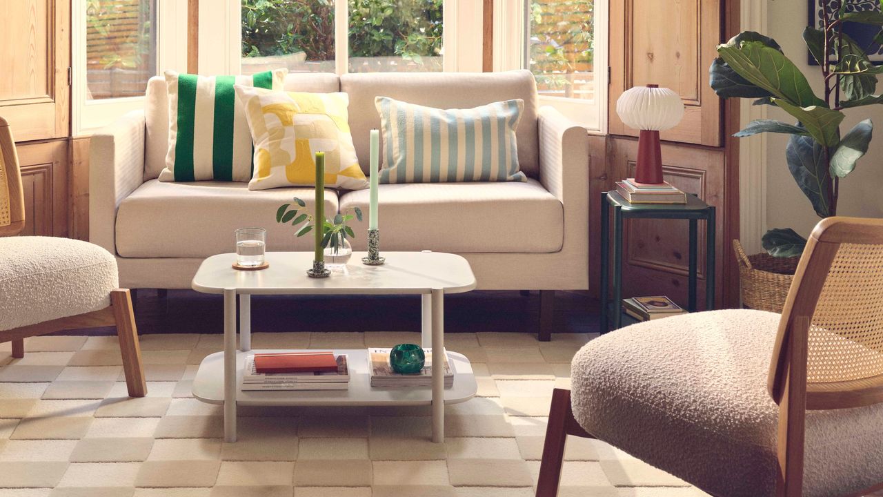 Tidy living room with a white sofa, a coffee table and a boucle chair