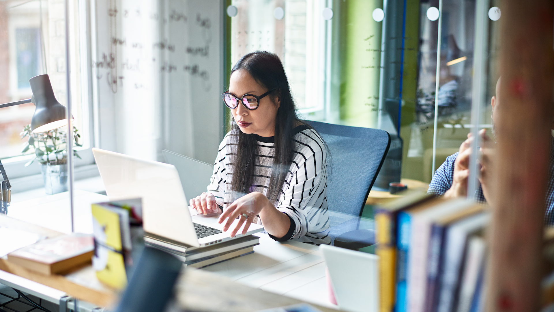 Woman working on laptop at desk