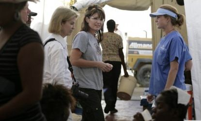 Sarah Palin tours a medical center in Cabaret, Haiti the day of the "disastrous" hairstyling photo op.