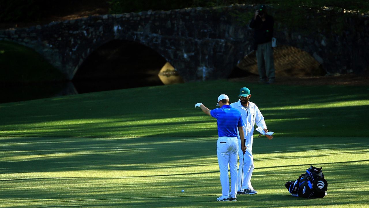 Photo of JOrdan Spieth dropping a ball on the 12th hole at Augusta